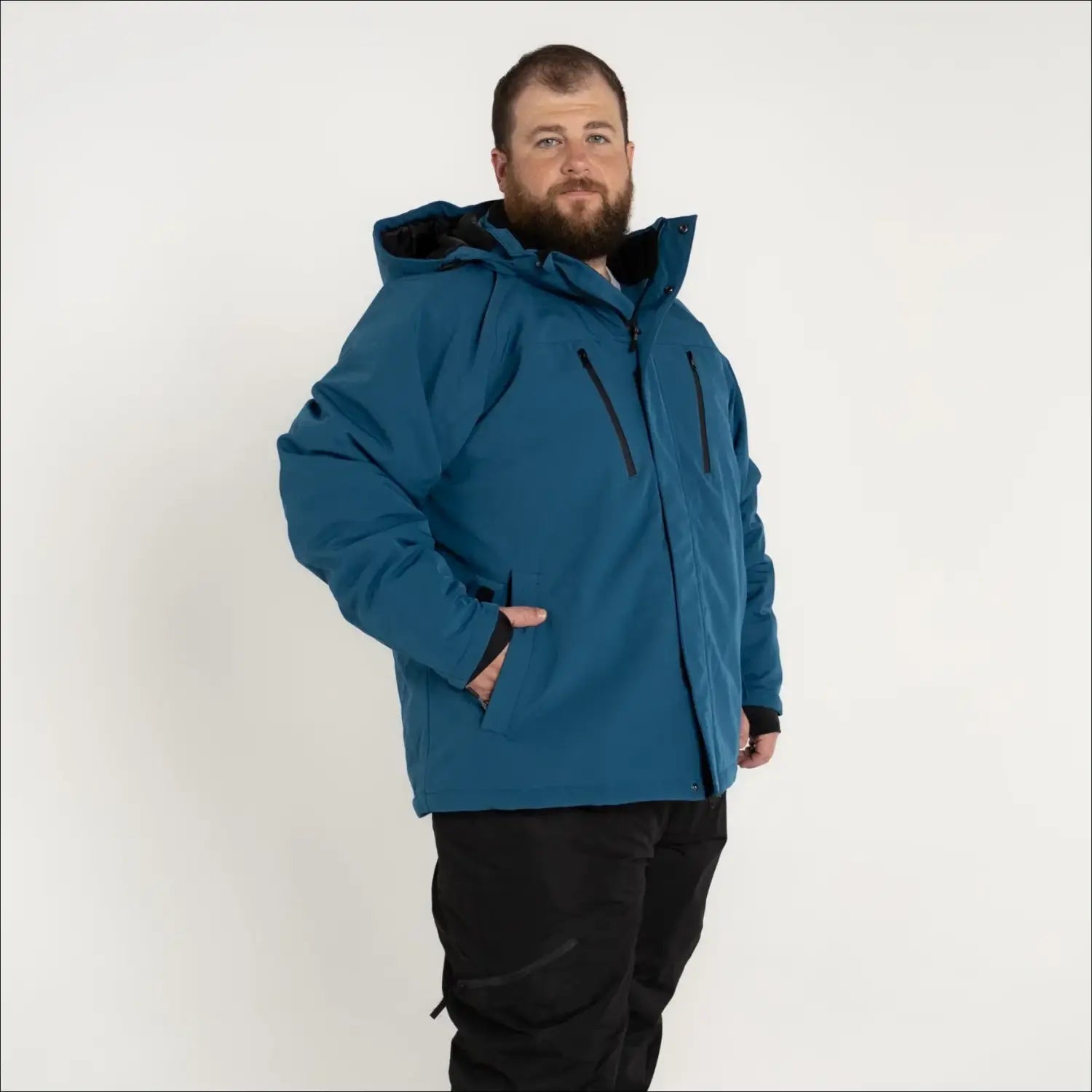 Man in teal Winter Jacket and black pants from Snow Country Outerwear Siberian III collection