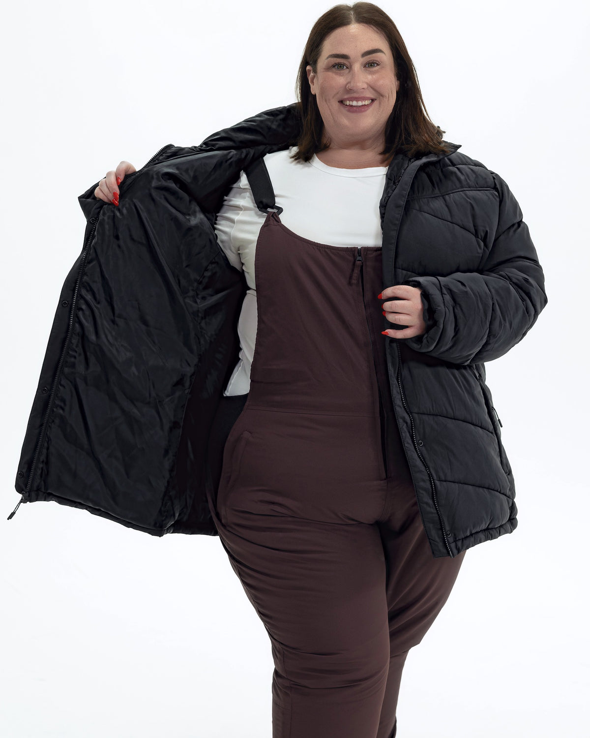 Black Geneva women's plus size mid length synthetic down jacket, worn open