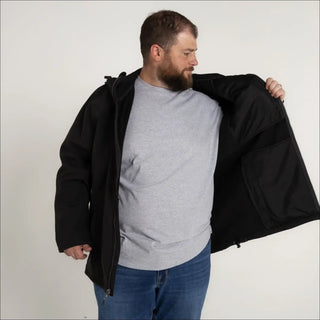 Man wearing black jacket from Men’s Big 2XL-7XL Cyclone Stretch Soft Shell Jacket Outerwear
