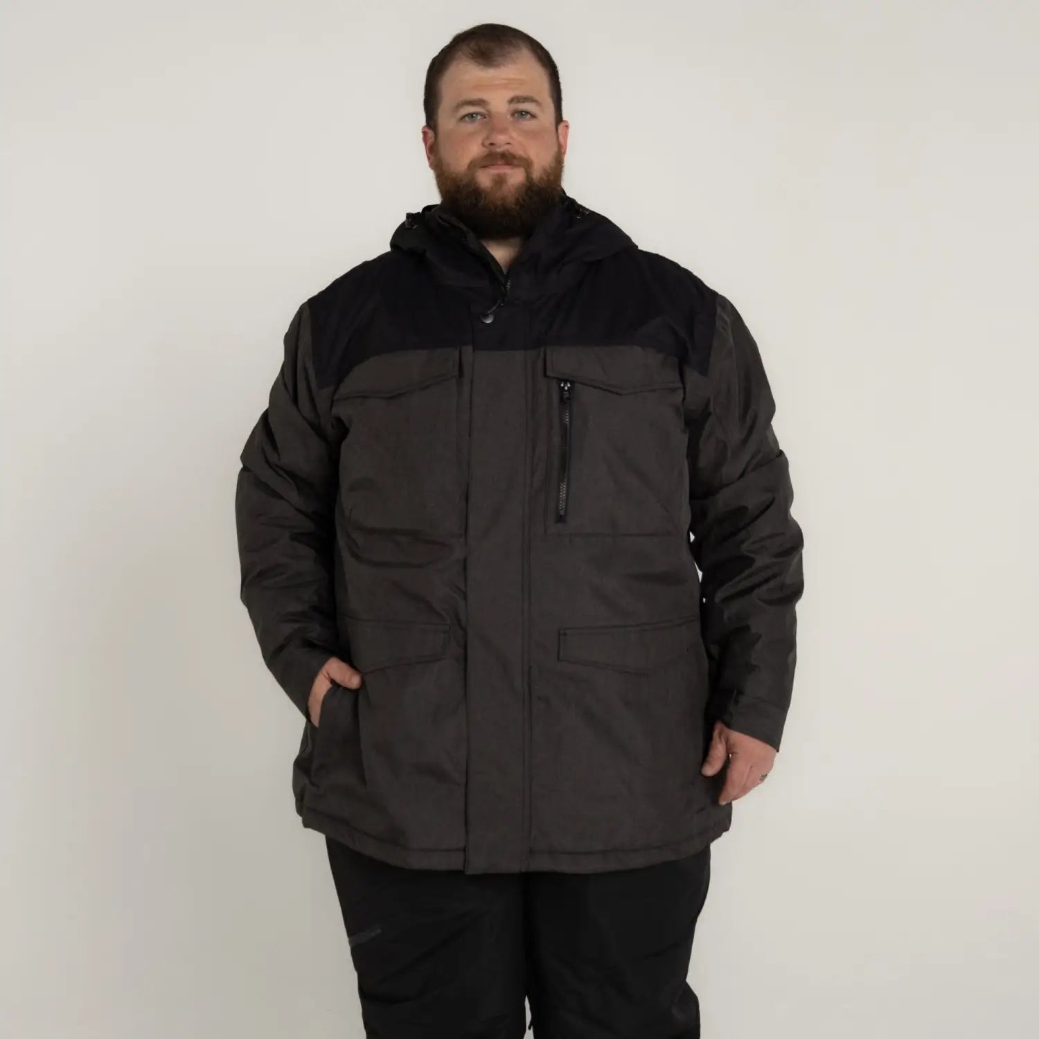 Man wearing Snow Country Outerwear black and gray insulated winter ski jacket