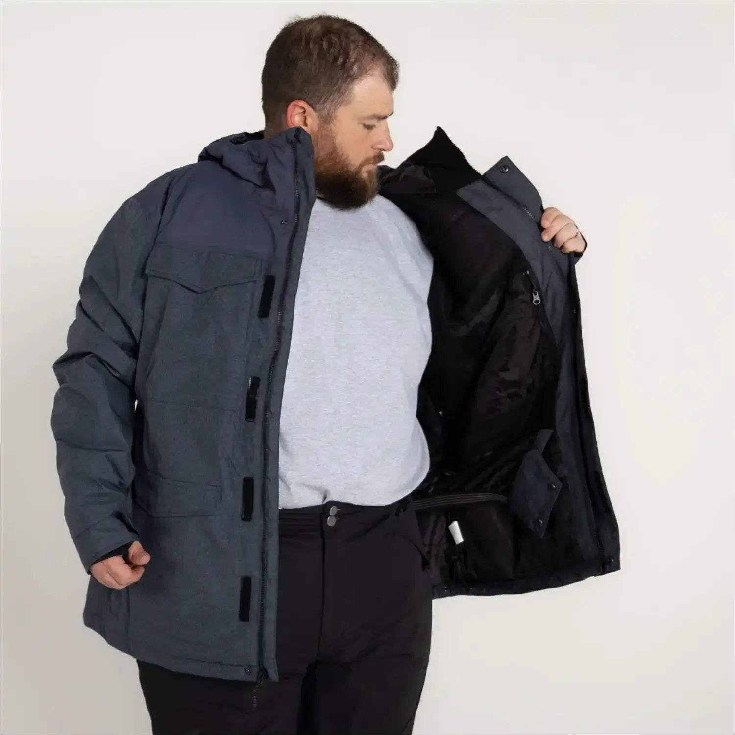 Man in a blue parka jacket from Snow Country Outerwear Men’s winter ski coat collection