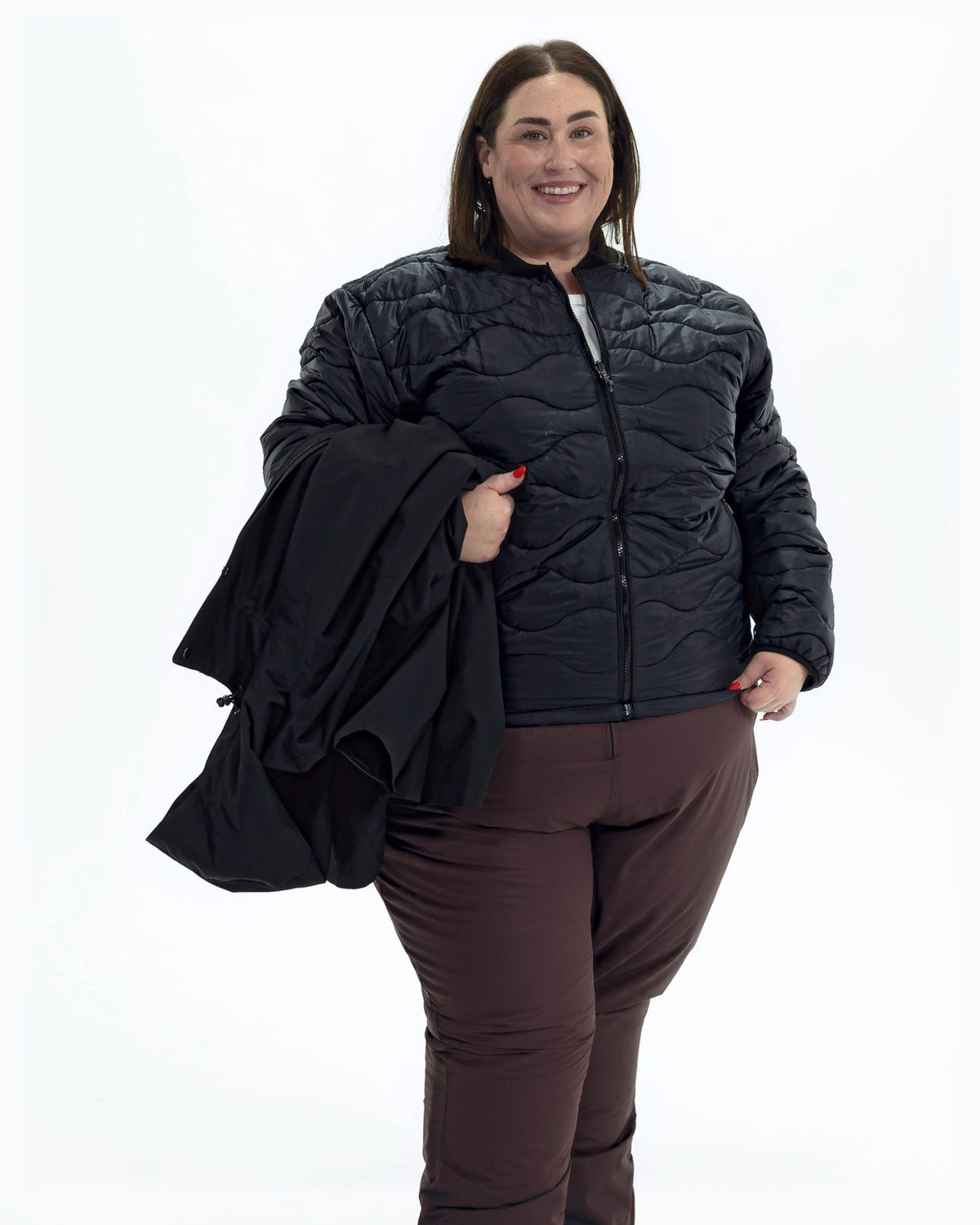 Black Swiss Systems women's plus size 3 in 1 winter jacket, quilted liner jacket with the shell over her arm