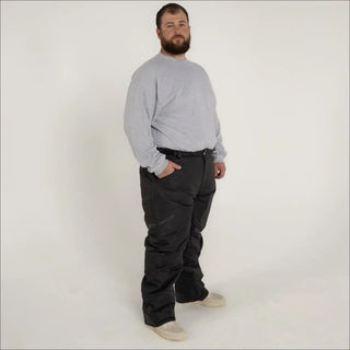 Man wearing gray sweatshirt and black pants in Snow Country Outerwear ski snow pants