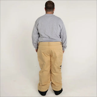 Tan snow pants for men in insulated winter technical ski and snowboarding clothing