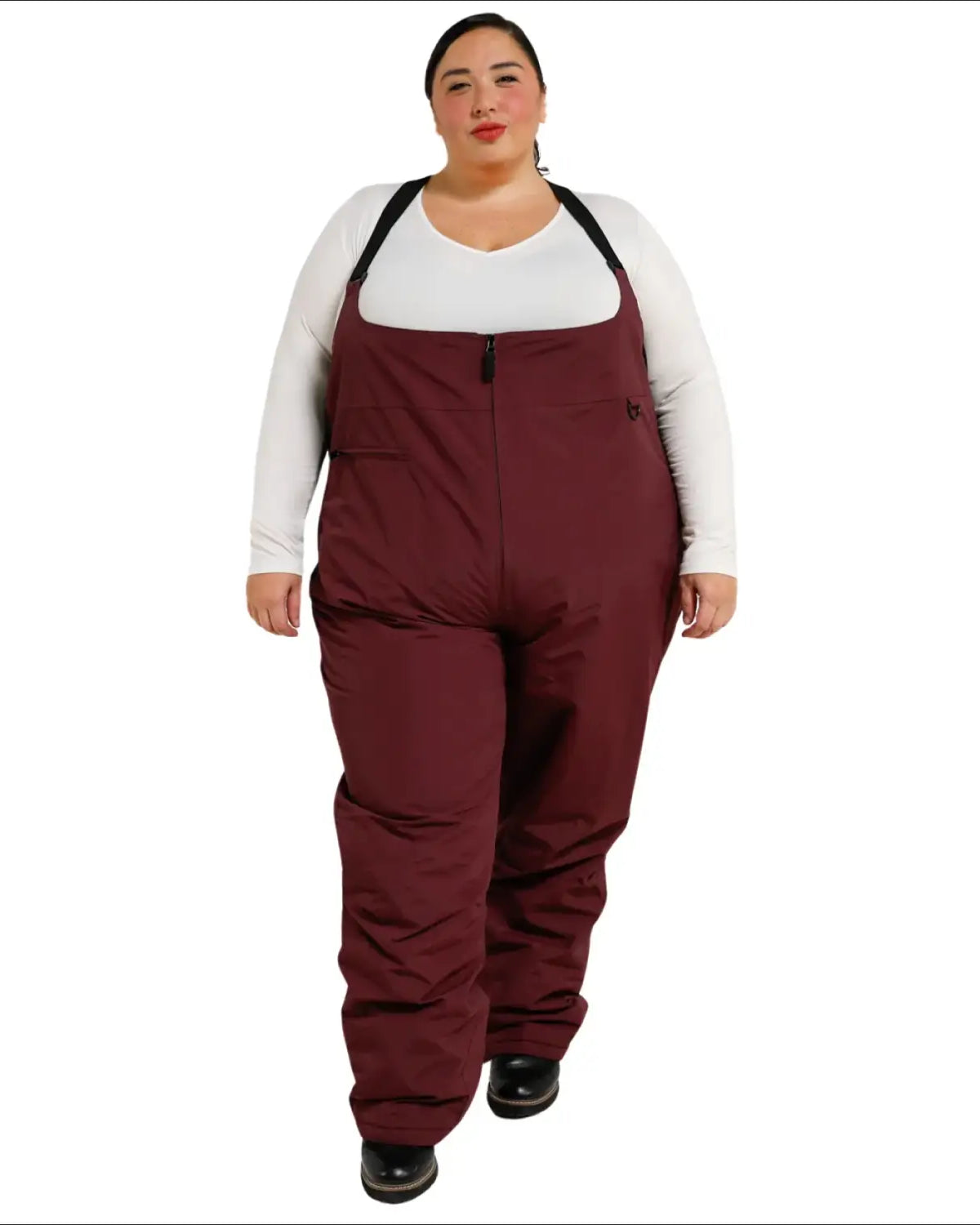 Woman wearing burgundy Snow Country Outerwear plus size winter snow ski bibs