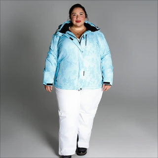 Woman wearing light blue insulated winter snow ski jacket and white snow pants