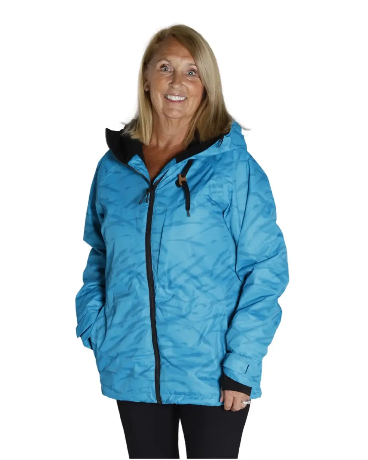 Woman in a blue hooded jacket wearing Snow Country Outerwear Ski Coat during winter
