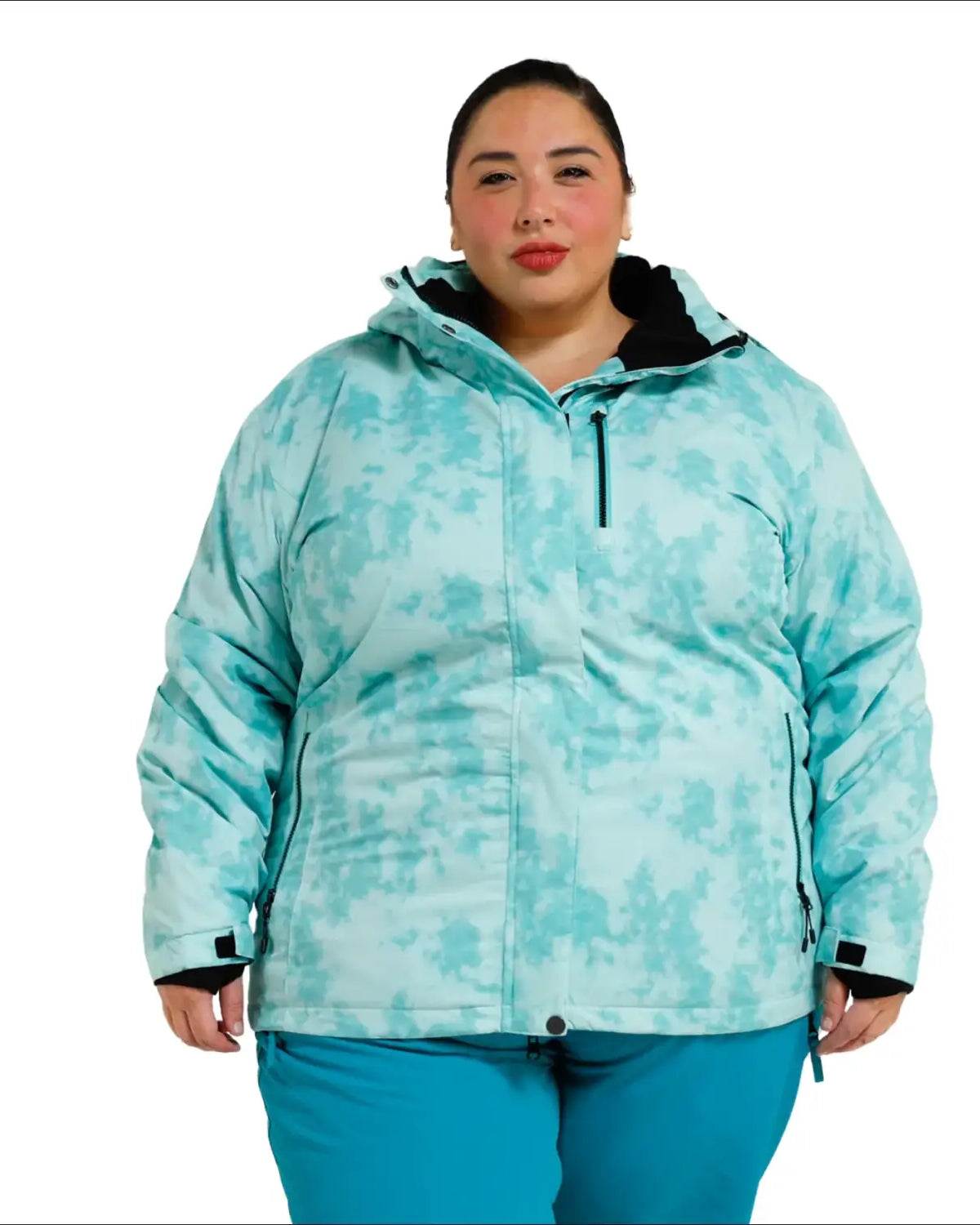 Woman wearing teal patterned insulated winter snow ski jacket from Bevel Snow Country Outerwear