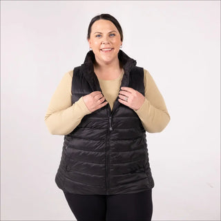 Woman wearing a black plus size synthetic down vest in outdoor setting