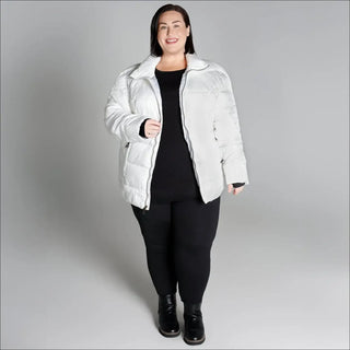 Woman wearing a white puffer jacket from Snow Country Outerwear Plus Size Lexington collection