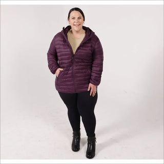 Woman in a hooded purple puffer jacket wearing Snow Country Outerwear’s packable down coat