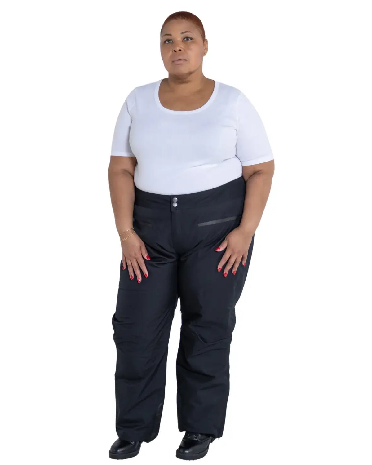 Woman in black snow pants and white t-shirt wearing Plus Size Trax Winter Ski Pants