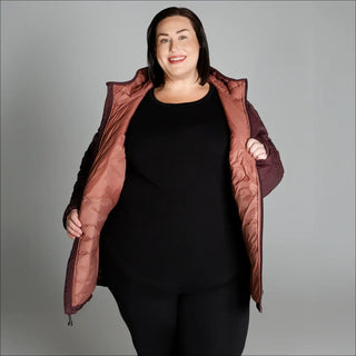 Woman wearing an open quilted packable down hooded coat ideal for snow country outdoor wear