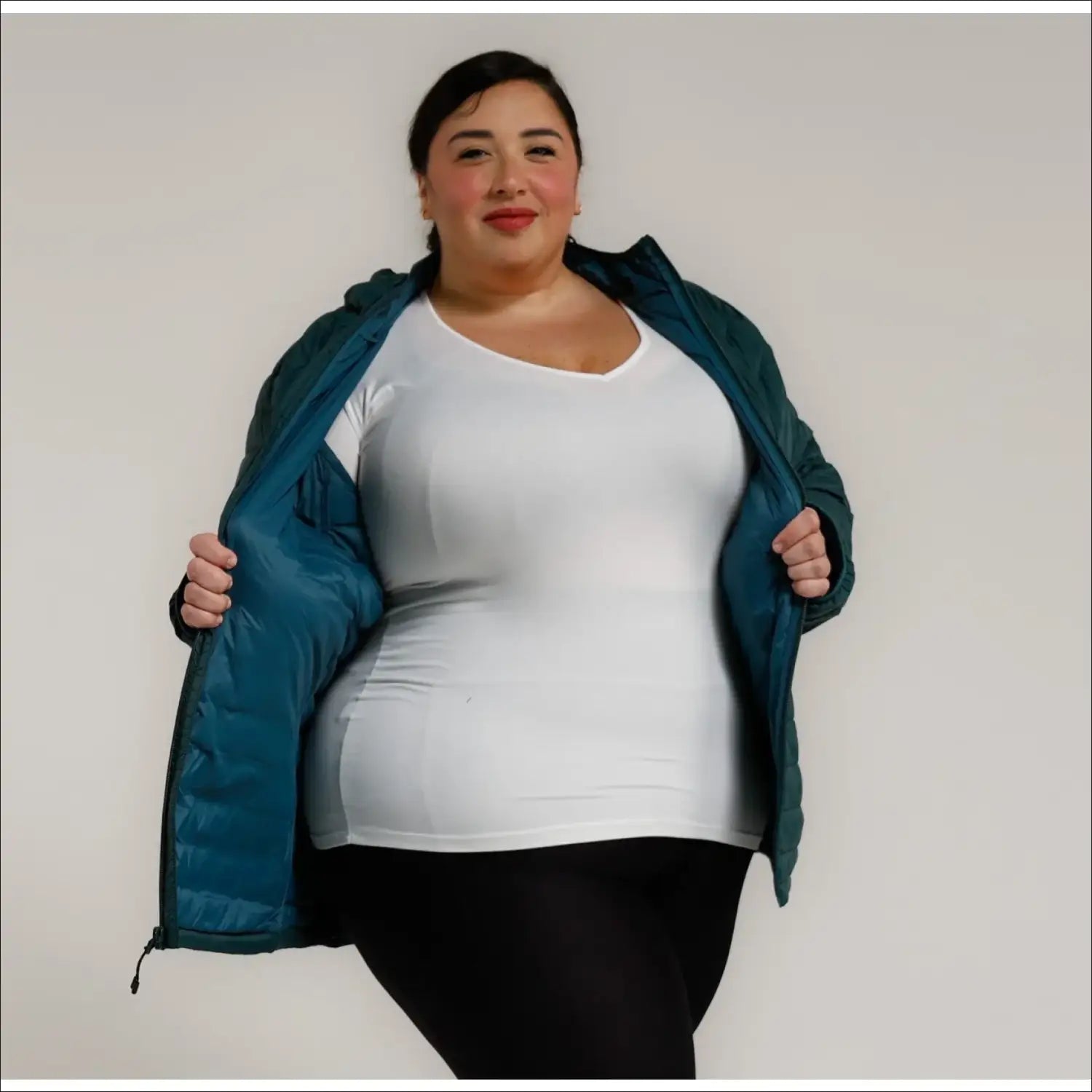 Woman in open teal puffer jacket showcasing women’s 1X-6X plus size packable down coat