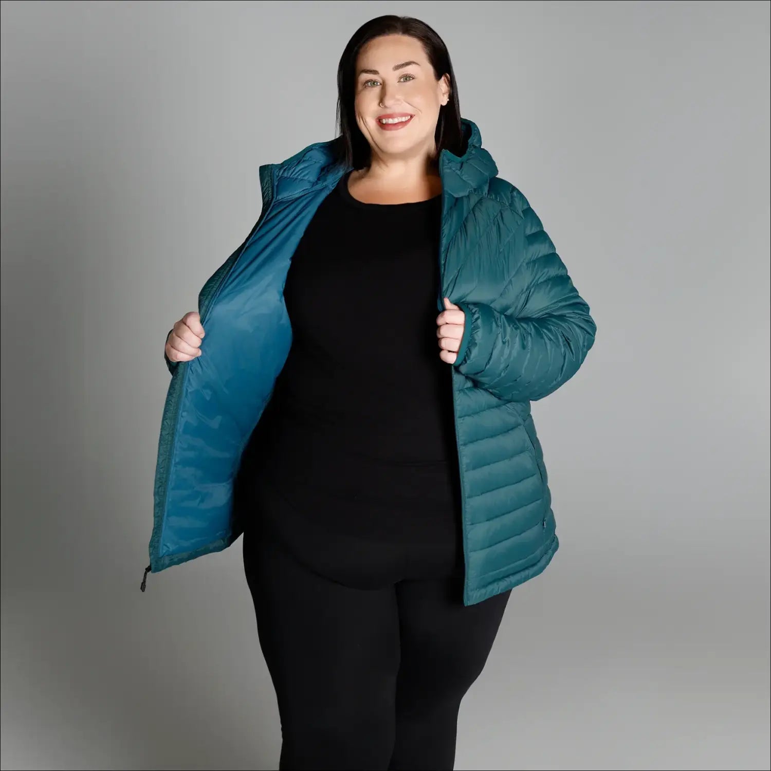 Teal puffer jacket displayed on black mannequin for Women’s 1X-6X Plus Size Packable Down Coat