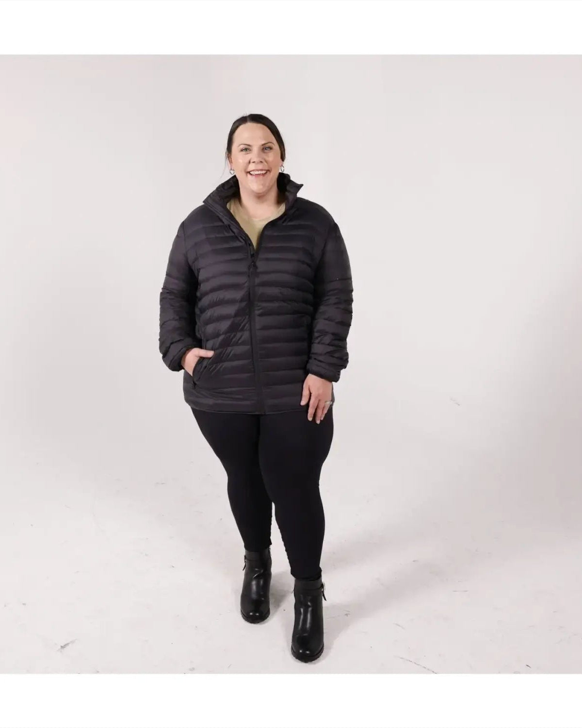 Woman in black puffer jacket wearing Sportcaster Women’s Plus Size Packable Down Jacket