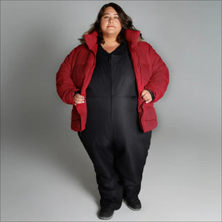 Woman in oversized red puffer jacket and black jumpsuit showcasing Snow Country Outerwear Luna coat
