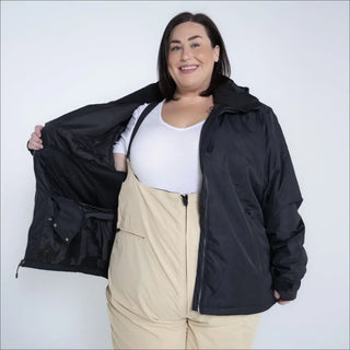 Woman in black jacket and beige overalls wearing Snow Country Plus Size Ski Jacket