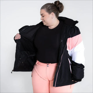Woman wearing black, pink, and white Snow Country Plus Size Ski Jacket for winter skiing