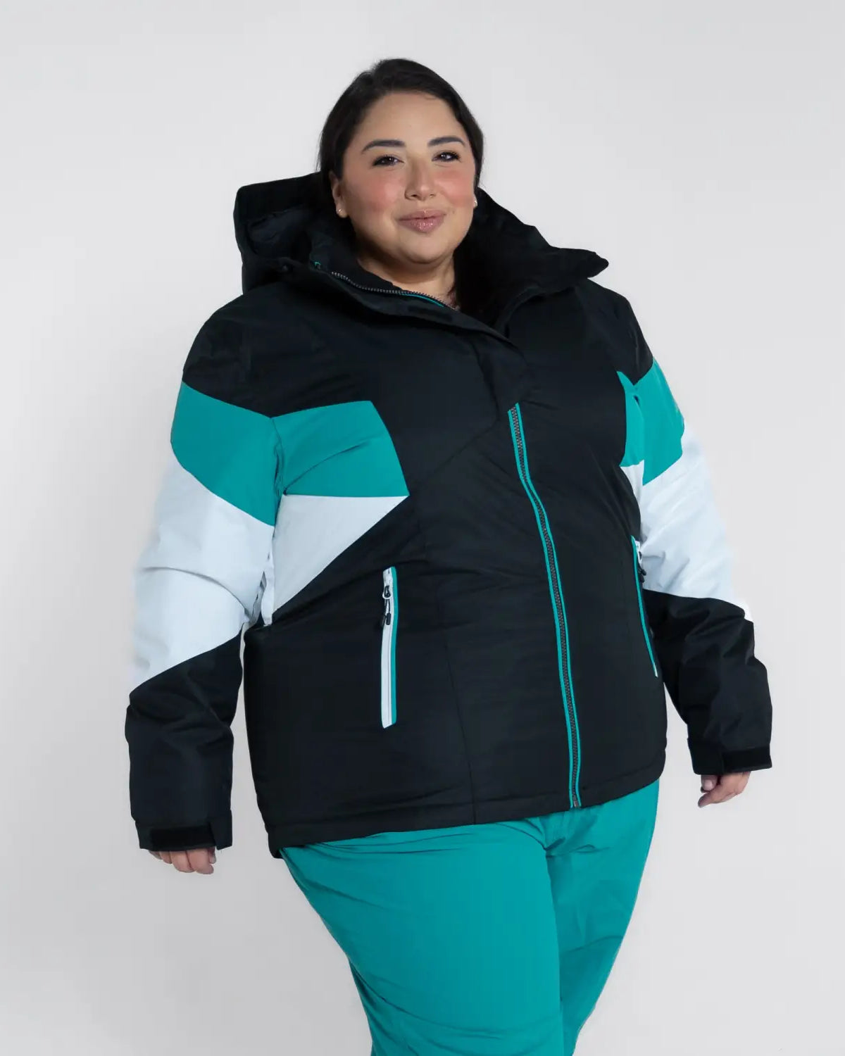 Woman wearing a color-blocked Snow Country Plus Size Ski Jacket and Pants for winter warmth