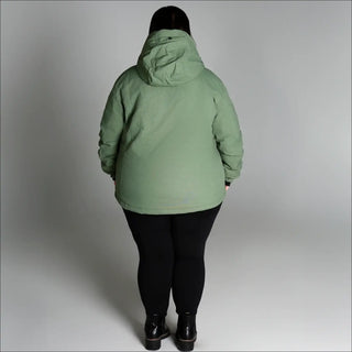 Woman wearing a light green hooded snow ski winter coat from Snow Country Outerwear