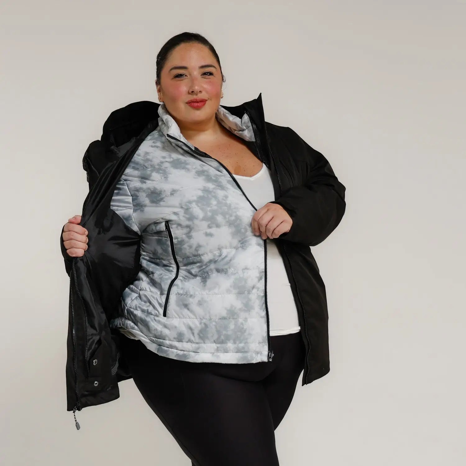 Woman wearing a black and gray plus size puffer winter coat in Snow Country Outerwear Alps