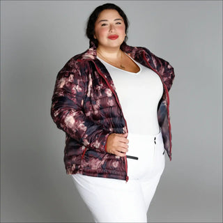 Woman wearing floral puffer jacket from Women’s Plus Size 1X-6X Winter Down Alternative Coat