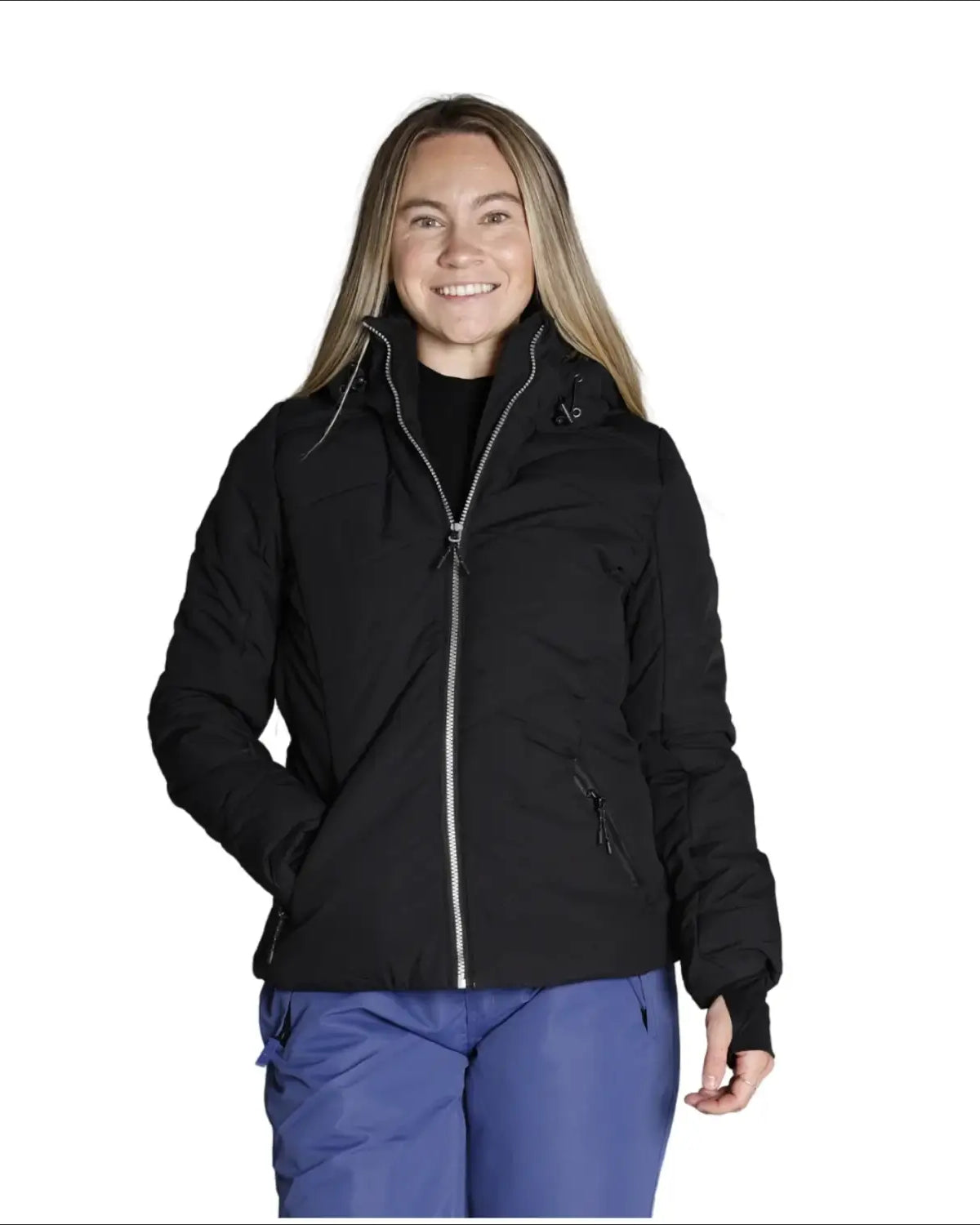 Woman wearing black puffer jacket and blue pants in Snow Country Outerwear Vail ski coat
