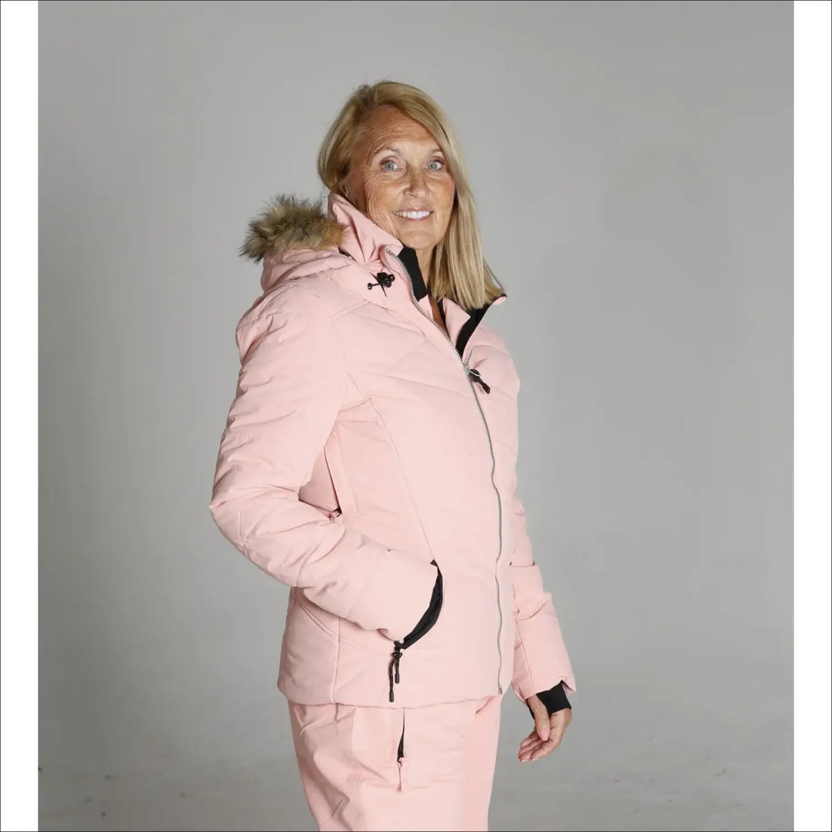 Pink winter jacket with fur-trimmed hood from Snow Country Outerwear Vail collection