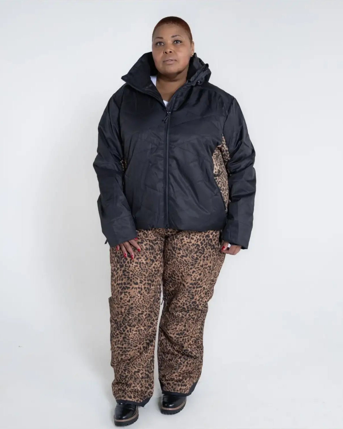 Woman in black jacket and leopard print pants wearing Women’s Plus Size Gemini Winter Ski Coat