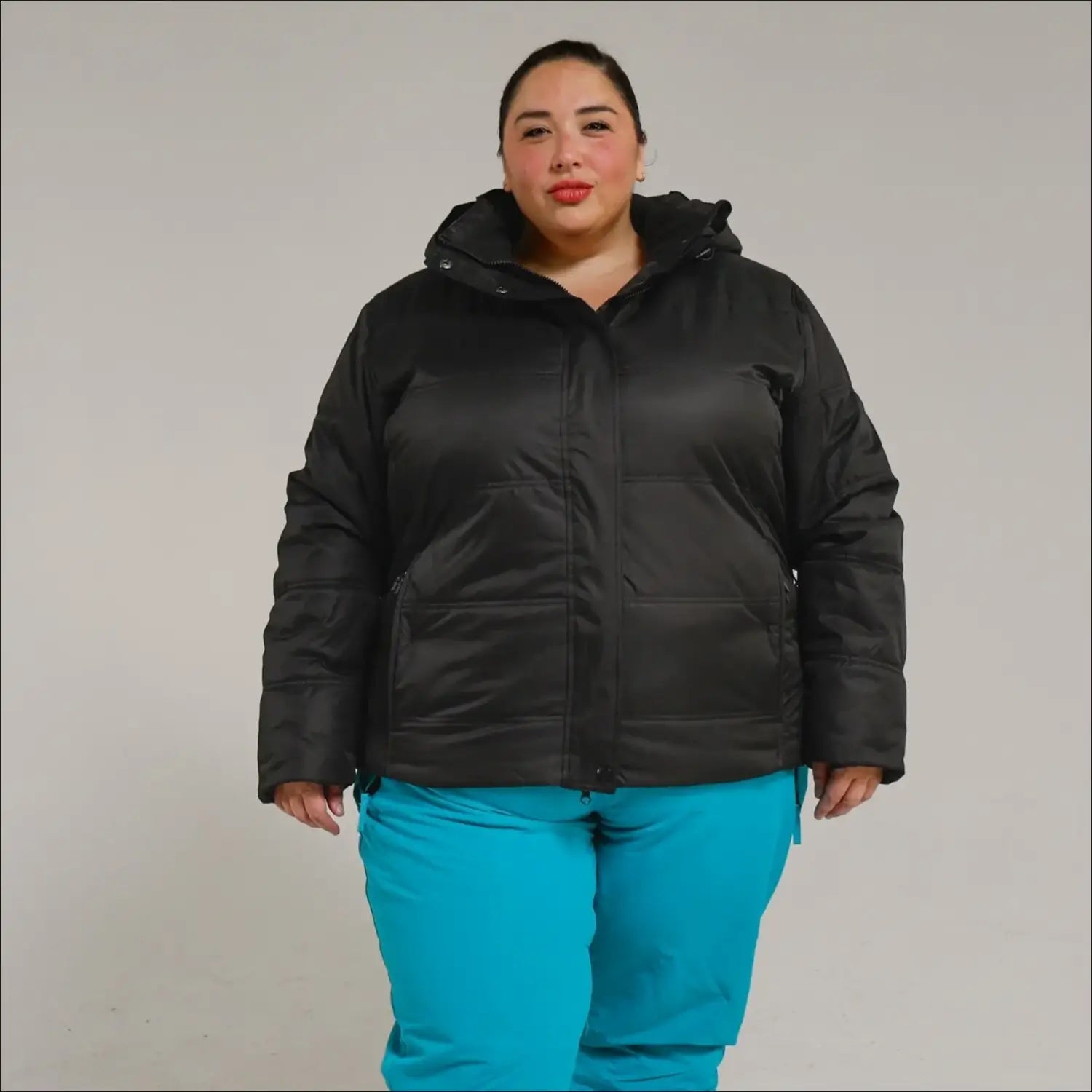 Black puffer jacket with blue pants from Snow Country Outerwear Womens Aspen Ski Coat