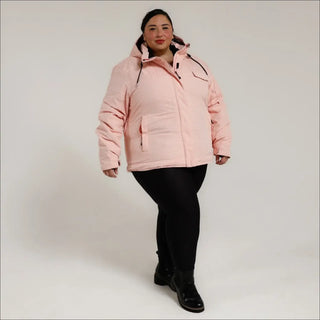 Woman wearing a pink puffer insulated snow board ski winter coat in Sugarcoat outerwear