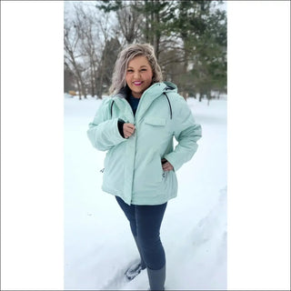 Woman in a light green insulated snow board winter ski coat outdoor outerwear