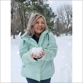 Woman in winter coat holding snowball, showcasing Sugarcoat Plus Size Snowboard Jacket