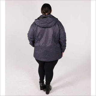 Woman wearing a dark blue hooded ski jacket and black leggings for Pulse Plus Size 3-in-1 Coat