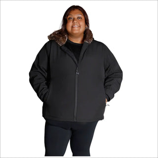 Woman wearing a black plus size faux fur soft shell jacket in fall or spring weather