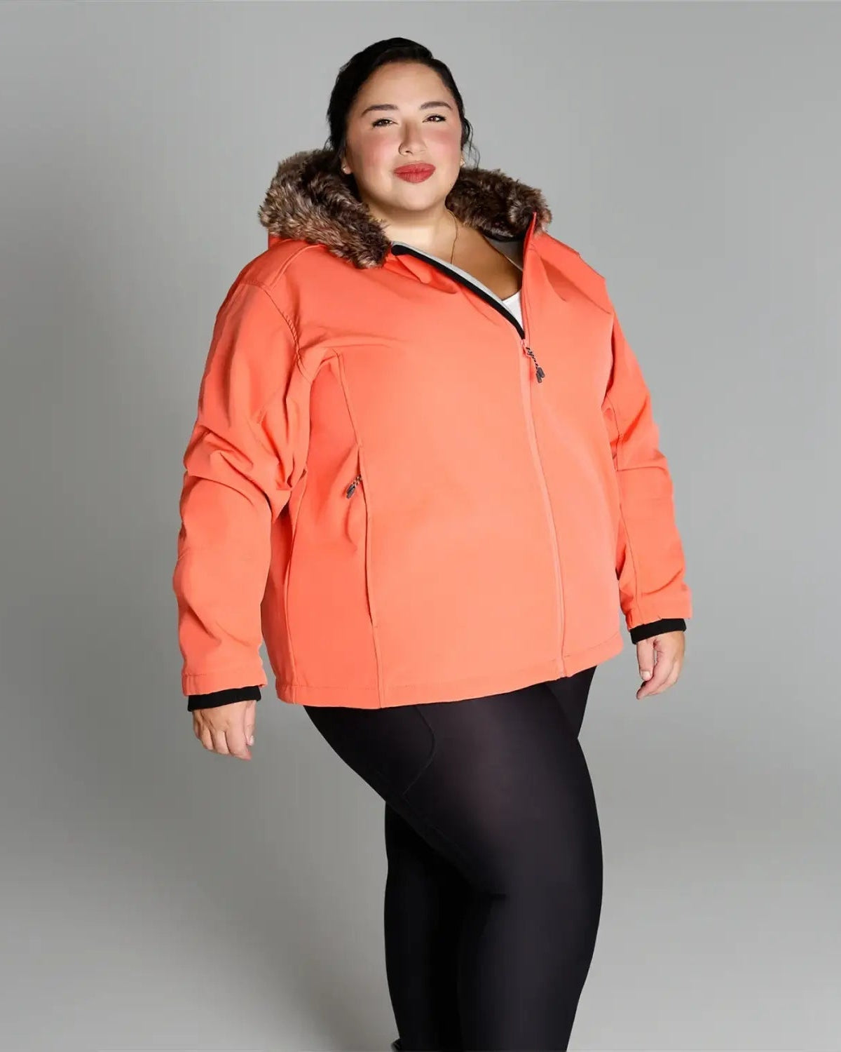 Coral-colored winter jacket with faux fur trim from Women’s Plus Size Alta Soft Shell Coat