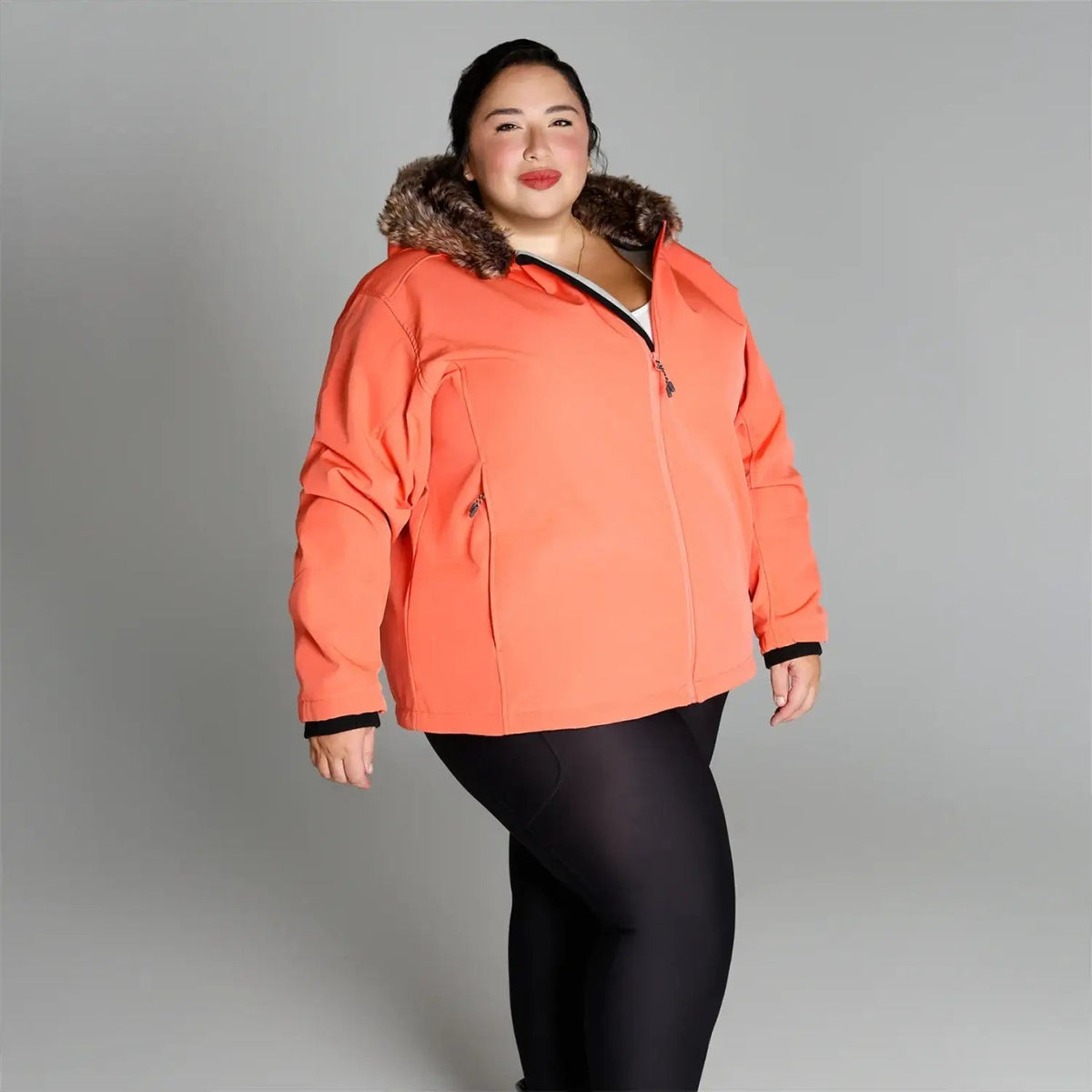 Coral-colored winter jacket with faux fur trim from Women’s Plus Size Alta Soft Shell Coat