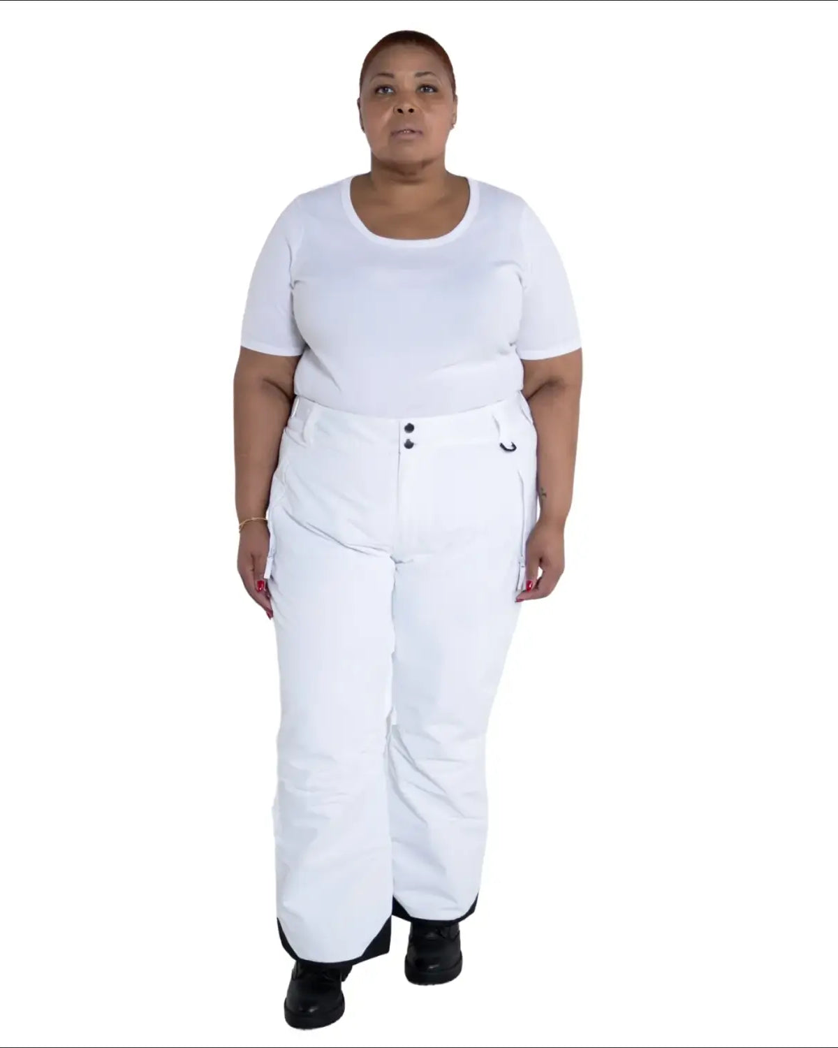 Woman wearing white ski pants and t-shirt in Snow Country Outerwear plus size insulated ski pants
