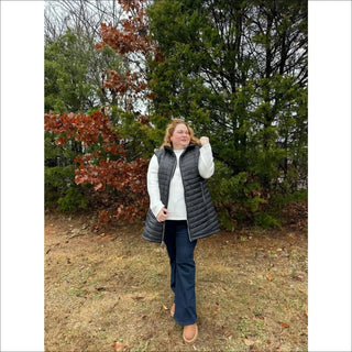 Woman wearing black quilted insulated plus size vest for outdoor winter outerwear