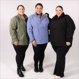 Three women wearing plus size stretch rain jackets and windbreakers at Sabre store