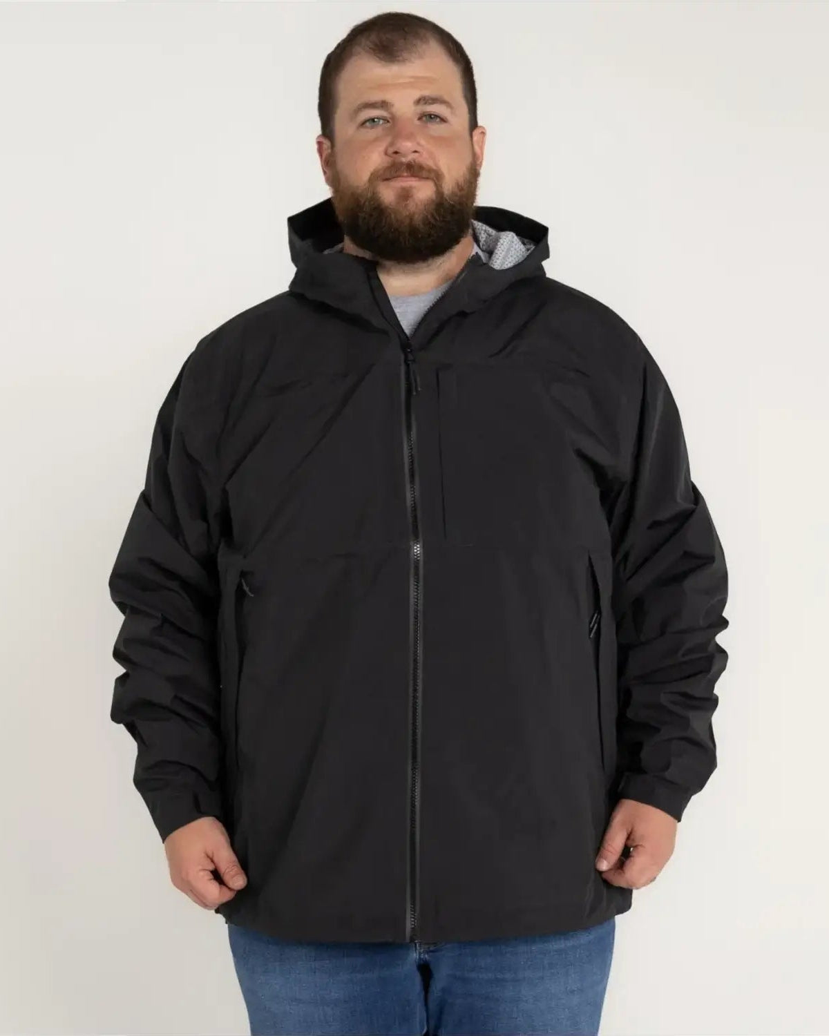 Man in black hooded jacket wearing Rugged Rainier Windbreaker Coat Snow Country Outerwear