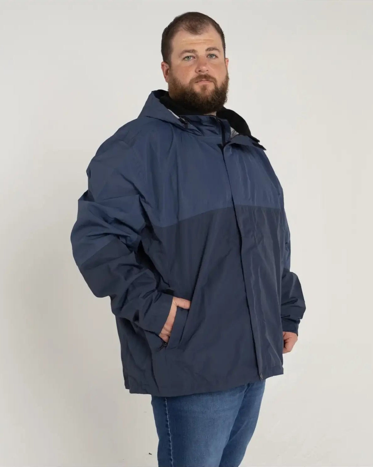 Man in blue rain jacket wearing Men’s Big 3XL-7XL Windbreaker Coat for Spring Fall Snow