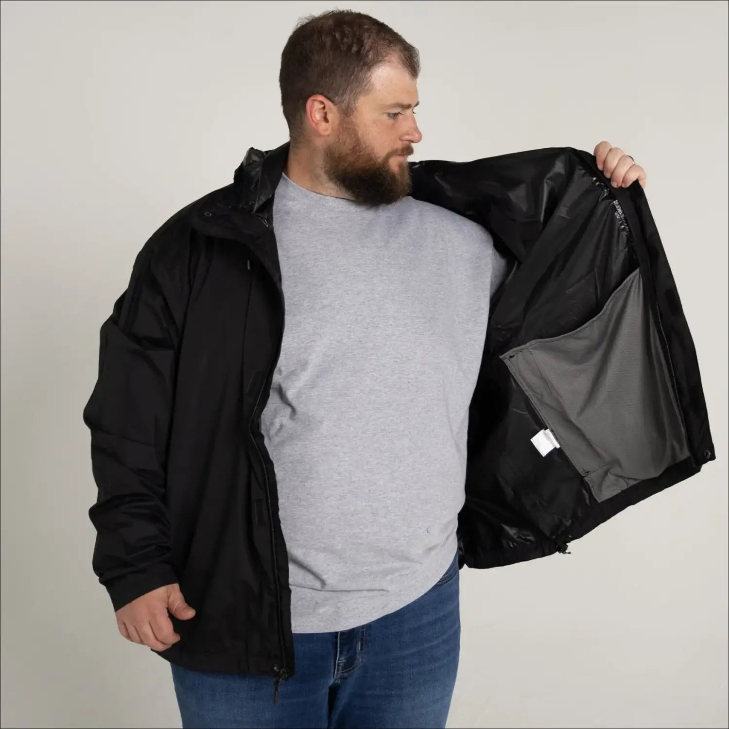 Black rain jacket with gray lining from Snow Country Outerwear Mens Packable Hooded Rain Jacket