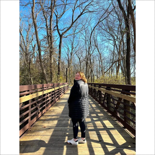 Woman in black puffer jacket wearing Plus Size Long Insulated Vest Outerwear Pristine