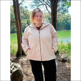 Woman in a light pink hooded waterproof rain jacket Camden Spring Fall product