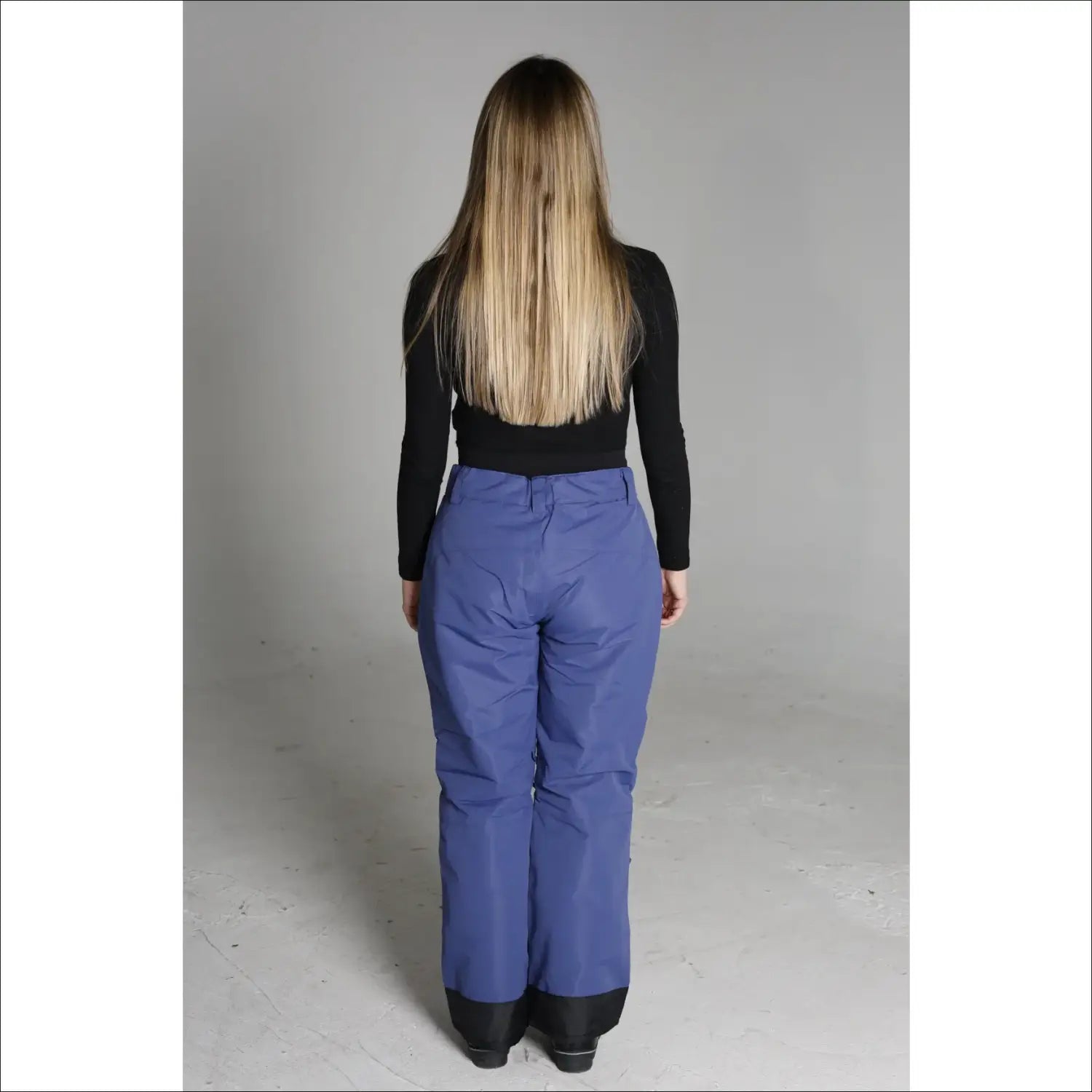 Woman wearing blue Snow Country Outerwear women’s ski pants for snowboarding