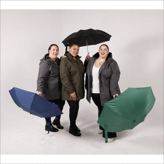 Three women with umbrellas wearing Women’s Plus Size Rain Jacket Trench Coat Berwick Spring Fall
