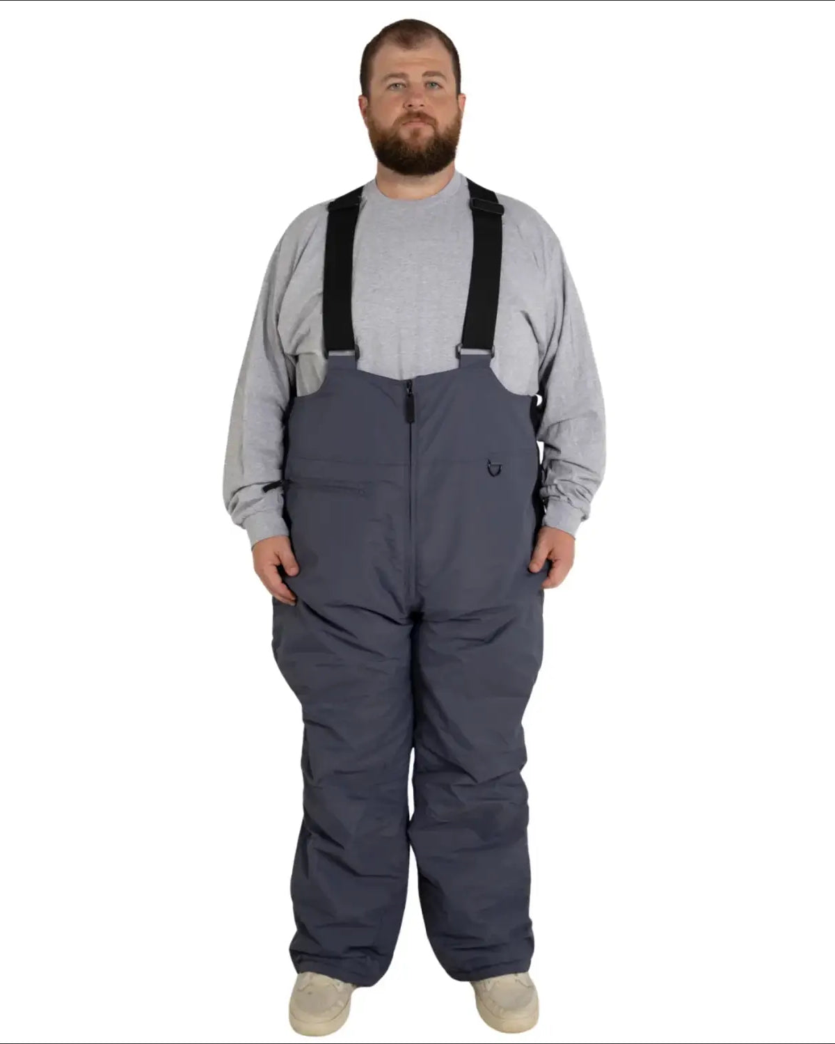 Man wearing gray bib overalls from Snow Country Outerwear men’s insulated ski snow bibs