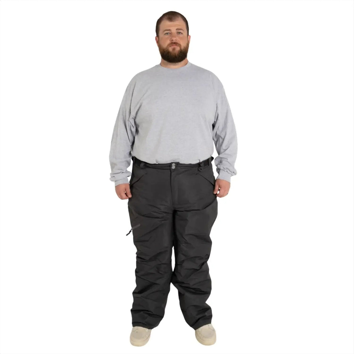 Man wearing gray long-sleeve shirt and dark snow pants from Snow Country Outerwear for skiing